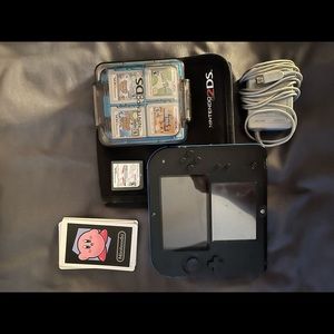 Nintendo 2DS with games, charger, and case